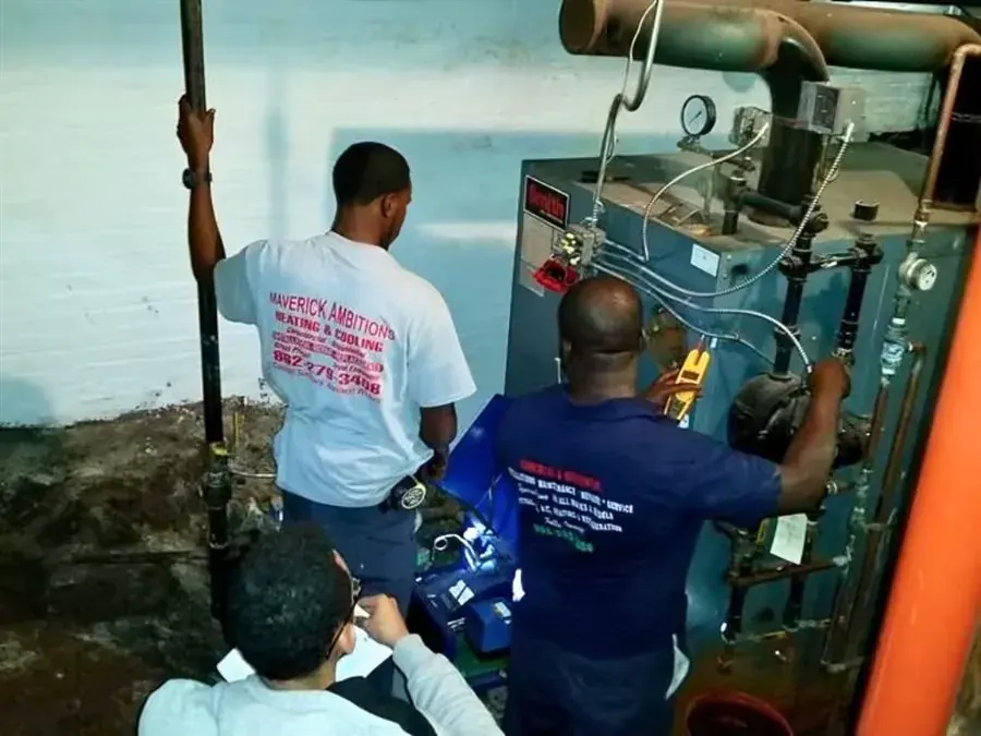 Technicians reading a meter while servicing a boiler in a mechanical room