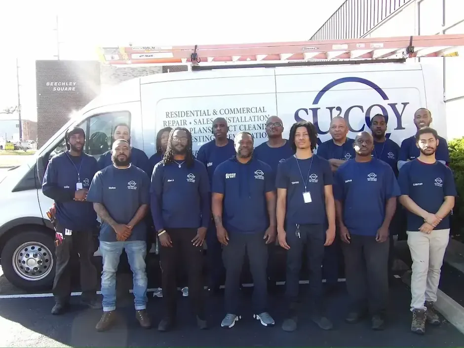 The Su&rsquo;Coy Heating, AC & Duct Cleaning team in front of a company van